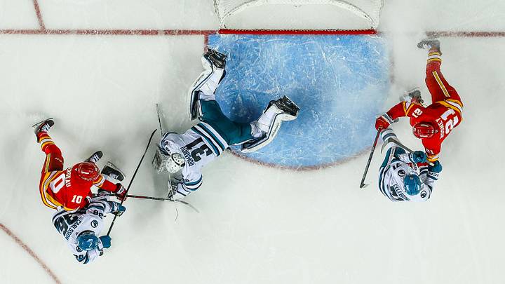 Apr 13, 2025; Calgary, Alberta, CAN; San Jose Sharks goaltender Georgi Romanov (31) makes a save against Calgary Flames left wing Jonathan Huberdeau (10) during the third period at Scotiabank Saddledome. Mandatory Credit: Sergei Belski-Imagn Images