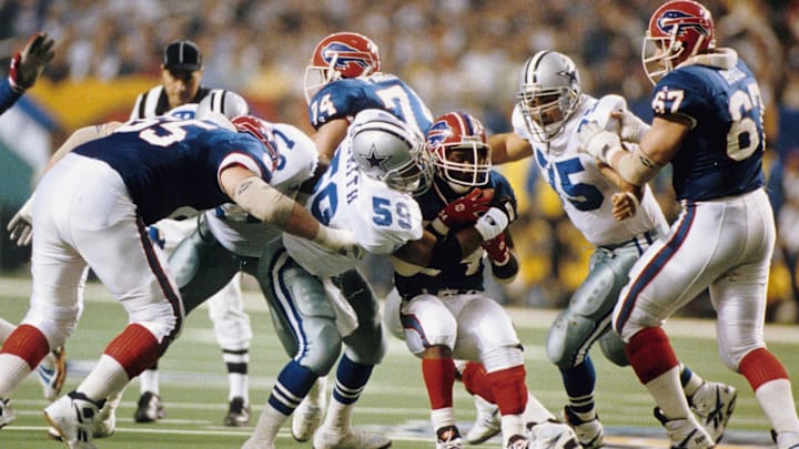 Jan 30, 1994; Atlanta, GA, USA; FILE PHOTO; Buffalo Bills Running Back #34 THURMAN THOMAS is stopped by Dallas Cowboys Linebacker #59 DARRIN SMITH during Super Bowl XXVIII at the Georgia Dome.  The Cowboys defeated the Buffalo Bills 30-13. Mandatory Credit: Photo By Imagn Images © Copyright 1994 Imagn Images