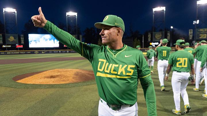 Oregon head baseball coach Mark Wasikowski salutes the crowd after the Ducks' 4-1 win over Oregon State to sweep the Eugene Regional at PK Park.