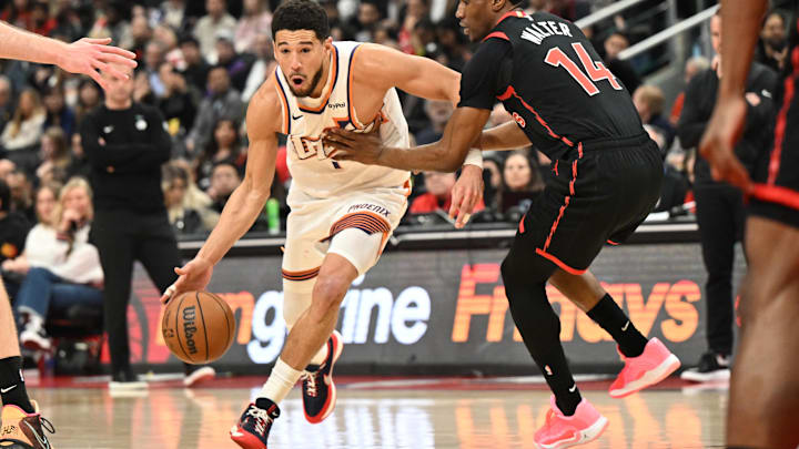 Mar 13, 2026; Toronto, Ontario, CAN; Phoenix Suns guard Devin Booker (1) dribbles the ball around Toronto Raptors guard Ja'Kobe Walter (14) in the first half at Scotiabank Arena. Mandatory Credit: Dan Hamilton-Imagn Images Mar 13, 2026; Toronto, Ontario, CAN; Phoenix Suns guard Devin Booker (1) dribbles the ball around Toronto Raptors guard Ja'Kobe Walter (14) in the first half at Scotiabank Arena. Mandatory Credit: Dan Hamilton-Imagn Images