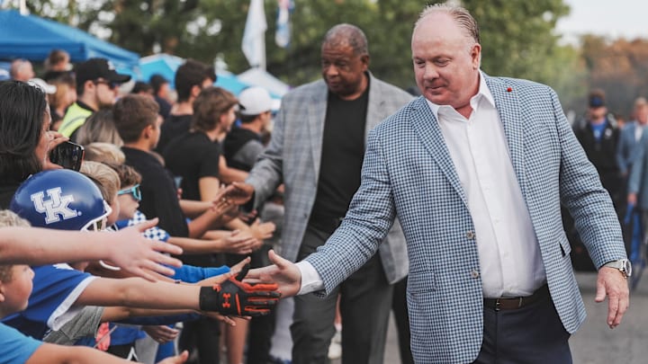 Kentucky football coach Mark Stoops greets the crowd at the team's Catwalk before the Vanderbilt game Saturday, Oct. 12, 2024 in Lexington, Ky. Behind him is associate head coach VInce Marrow.
