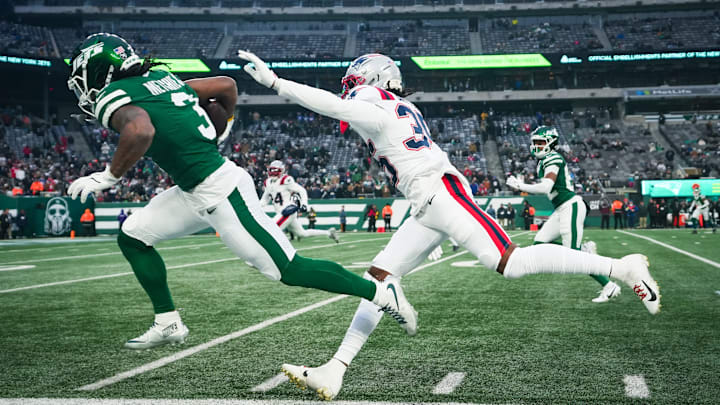 New York Jets wide receiver John Metchie III (3) runs the ball as New England Patriots safety John Saunders Jr. (23) defends during a game at MetLife Stadium, Dec 28, 2025, East Rutherford, NJ, USA.