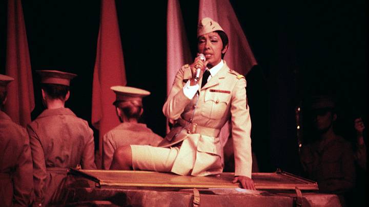 Josephine Baker performing in a military uniform.