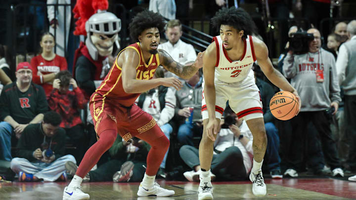 Feb 23, 2025; Piscataway, New Jersey, USA; Rutgers Scarlet Knights guard Dylan Harper (2) sets the play while being defended by USC Trojans forward Saint Thomas (0) during the first half at Jersey Mike's Arena. Mandatory Credit: John Jones-Imagn Images