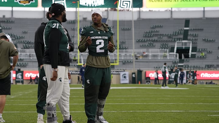 Nov 15, 2025; East Lansing, Michigan, USA; Michigan State quarterback Aidan Chiles (2) chats with Michigan State offensive lineman Kristian Phillips (71) during warmups before a game against the Penn State Nittany Lions at Spartan Stadium. Mandatory Credit: Brendan Mullin-Imagn Images