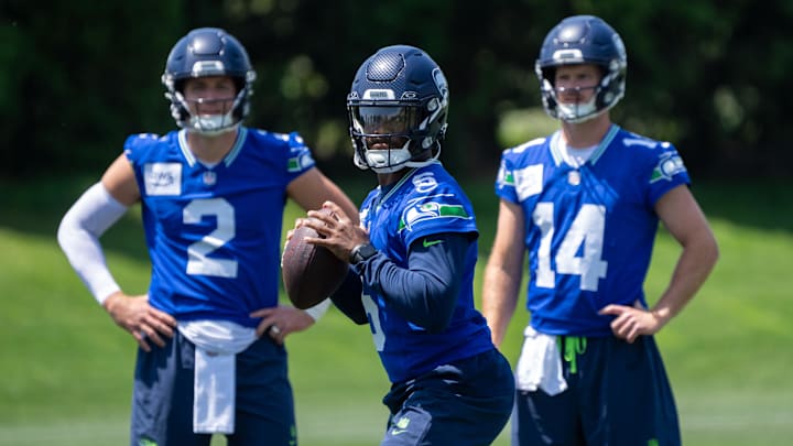 Seattle Seahawks QB Jalen Milroe looks to pass as Drew Lock and Sam Darnold during mini-camp at Virginia Mason Athletic Center.
