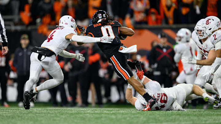 Nov 23, 2024; Corvallis, Oregon, USA; Oregon State Beavers running back Anthony Hankerson (0) runs away from a tackle by Washington State Cougars defensive back Kapena Gushiken (4) and linebacker Parker McKenna (46) during the third quarter at Reser Stadium. Mandatory Credit: Craig Strobeck-Imagn Images
