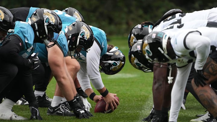 Oct 16, 2024; Watford, United Kingdom; A general overall view of helmets at the line of scrimmage as Jacksonville Jaguars long snapper Ross Matiscik (46) snaps the ball during practice at The Grove. Mandatory Credit: Kirby Lee-Imagn Images