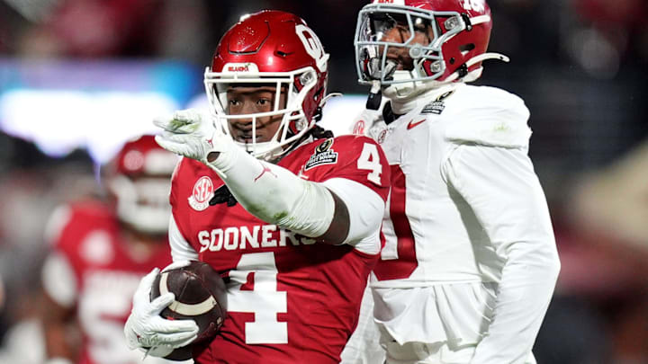 Oklahoma's Deion Burks (4) celebrates a reception next to Alabama's Justin Jefferson (10) in the first half of the College Football Playoff game between the University of Oklahoma Sooners (OU) and the Alabama Crimson Tide at the Gaylord Family - Oklahoma Memorial Stadium in Norman, Okla., Friday, Dec. 19, 2025.