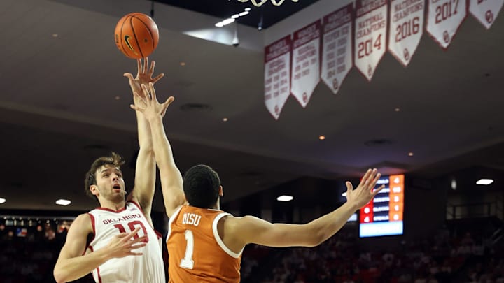 Sam Godwin shoots over Dylan Disu as the University of Oklahoma Sooner men's basketball team plays the University of Texas Longhorns on Jan 23, 2024; Norman, Okla, [USA]; at Lloyd Noble. Mandatory Credit: Steve Sisney-The Oklahoman