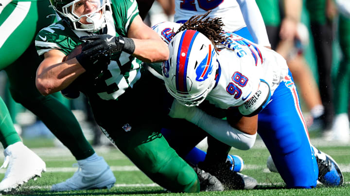 New York Jets running back Isaiah Davis (32) is tackled by Buffalo Bills defensive tackle T.J. Sanders (98), Sunday, September 14, 2025, in East Rutherford.