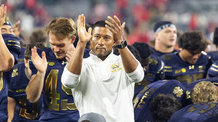 Sep 6, 2026; Green Bay, Wisconsin, USA; Notre Dame Fighting Irish head coach leads the team in singing the Notre Dame fight song to fans after defeating the against the Wisconsin Badgers at Lambeau Field. Sep 6, 2026; Green Bay, Wisconsin, USA; Notre Dame Fighting Irish head coach leads the team in singing the Notre Dame fight song to fans after defeating the against the Wisconsin Badgers at Lambeau Field.