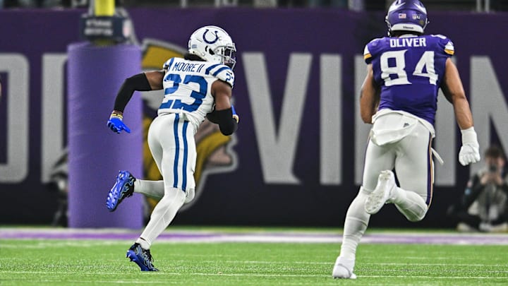 Nov 3, 2024; Minneapolis, Minnesota, USA; Indianapolis Colts cornerback Kenny Moore II (23) returns a fumble for a touchdown as Minnesota Vikings tight end Josh Oliver (84) pursues during the second quarter at U.S. Bank Stadium. Mandatory Credit: Jeffrey Becker-Imagn Images