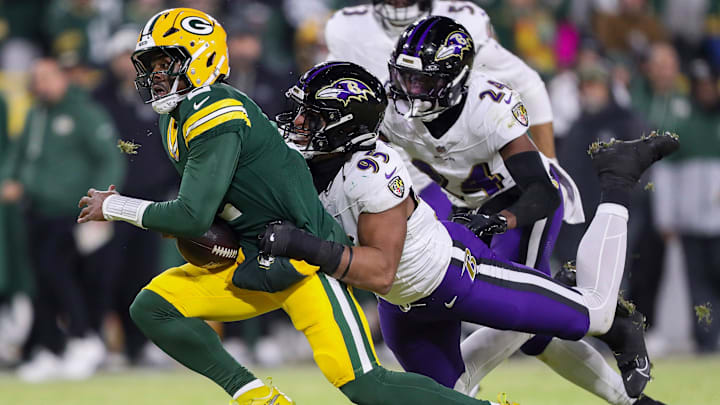 Green Bay Packers quarterback Malik Willis (2) is tackled by Baltimore Ravens linebacker Tavius Robinson (95) on Saturday, December 27, 2025, at Lambeau Field in Green Bay, Wis.