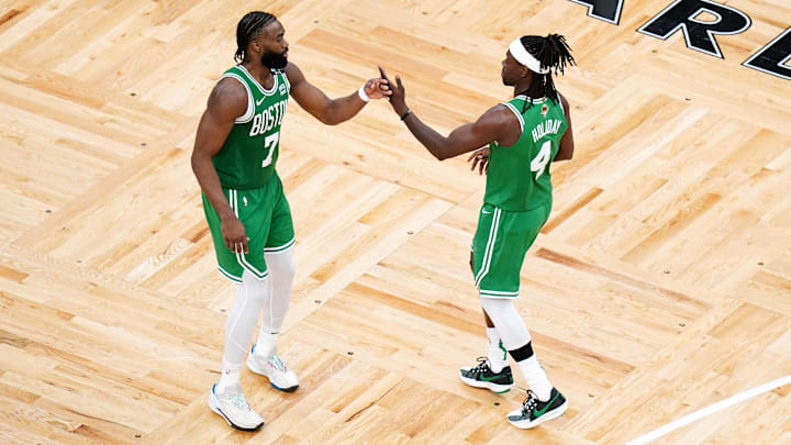 Jun 17, 2024; Boston, Massachusetts, USA; Boston Celtics guard Jaylen Brown (7) and guard Jrue Holiday (4) react in the third quarter against the Dallas Mavericks during game five of the 2024 NBA Finals at TD Garden. Mandatory Credit: David Butler II-Imagn Images
