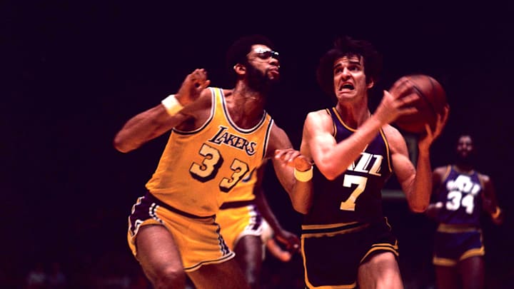 “Pistol” Pete Maravich scoops up a layup attempt against the Lakers' Kareem Abdul-Jabbar