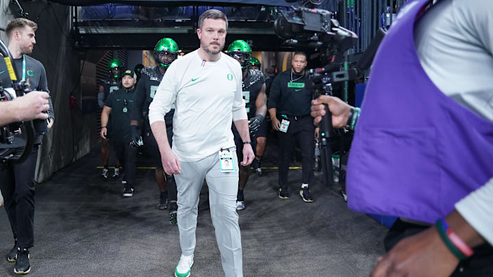 Dec 7, 2024; Indianapolis, IN, USA; Oregon Ducks head coach Dan Lanning runs out for warmups against the Penn State Nittany Lions in the 2024 Big Ten Championship game at Lucas Oil Stadium. Mandatory Credit: Robert Goddin-Imagn Images