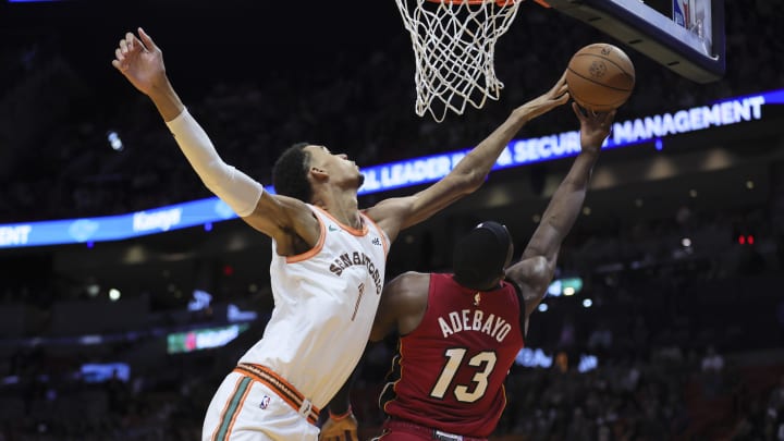 Feb 7, 2024; Miami, Florida, USA; San Antonio Spurs center Victor Wembanyama (1) blocks a shot against Miami Heat center Bam Adebayo (13) during the first quarter at Kaseya Center. Mandatory Credit: Sam Navarro-USA TODAY Sports
