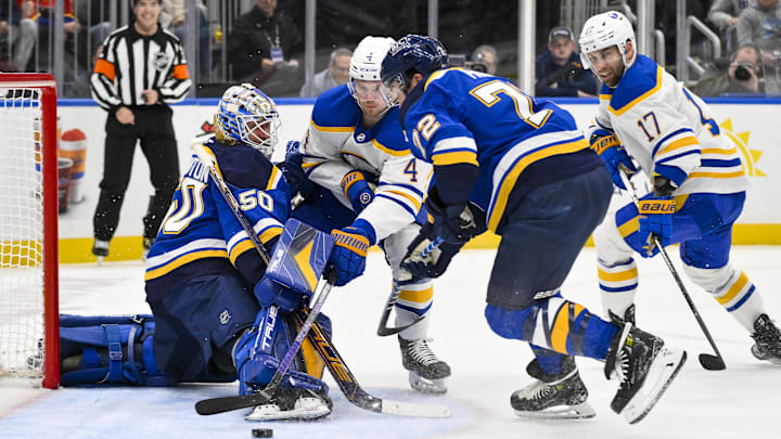 Dec 29, 2024; St. Louis, Missouri, USA; St. Louis Blues goaltender Jordan Binnington (50) and defenseman Justin Faulk (72) defend the net against Buffalo Sabres defenseman Bowen Byram (4) during the first period at Enterprise Center. Mandatory Credit: Jeff Curry-Imagn Images Dec 29, 2024; St. Louis, Missouri, USA; St. Louis Blues goaltender Jordan Binnington (50) and defenseman Justin Faulk (72) defend the net against Buffalo Sabres defenseman Bowen Byram (4) during the first period at Enterprise Center. Mandatory Credit: Jeff Curry-Imagn Images