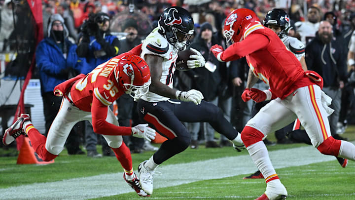 Dec 7, 2025; Kansas City, Missouri, USA; Houston Texans wide receiver Nico Collins (12) is tackled by Kansas City Chiefs cornerback Jaylen Watson (35) during the second quarter at GEHA Field at Arrowhead Stadium. Mandatory Credit: Amy Kontras-Imagn Images