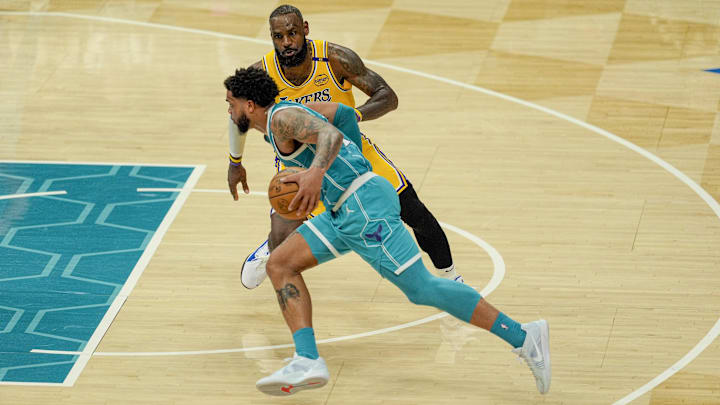 Charlotte Hornets forward Miles Bridges drives to the basket against Los Angeles Lakers forward LeBron James during the second half at the Spectrum Center.