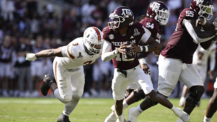 Dec 20, 2025; College Station, TX, USA; Texas A&M Aggies quarterback Marcel Reed (10) scrambles against Miami Hurricanes defensive lineman Akheem Mesidor (3) during the second half of the first round game of the CFP National Playoff at Kyle Field. Mandatory Credit: Jerome Miron-Imagn Images