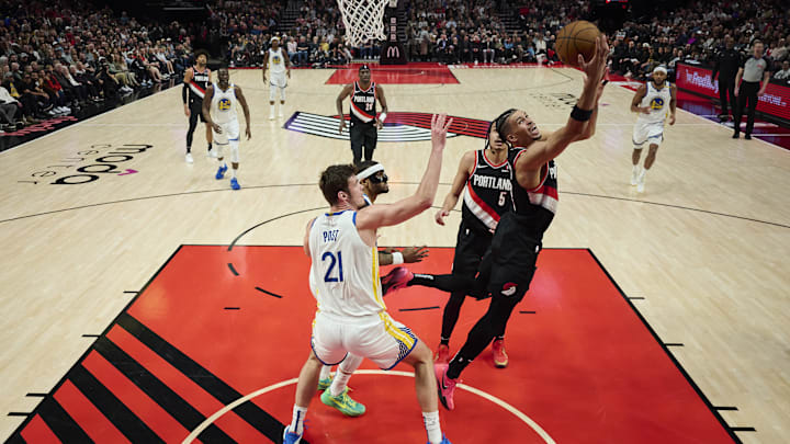 Apr 11, 2025; Portland, Oregon, USA; Portland Trail Blazers forward Toumani Camara (33) scores a layup during the first half against Golden State Warriors center Quinten Post (21) at Moda Center. Mandatory Credit: Troy Wayrynen-Imagn Images