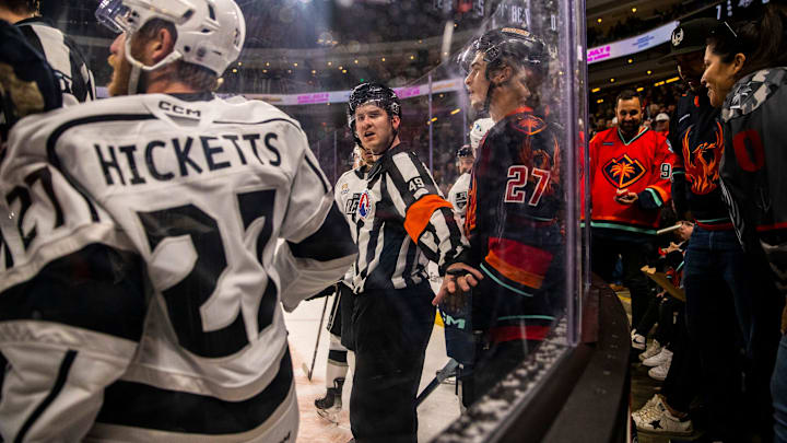 A referee steps in between Ontario defenseman Joe Hicketts (27) and Coachella Valley forward Ryan Winterton (27) during the first period of Game 2 of the Pacific Division Finals at Acrisure Arena in Palm Desert, Calif., Friday, May 17, 2024.