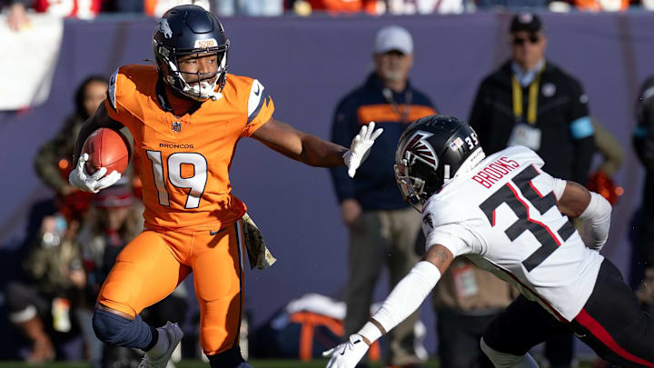 November 17, 2024, Denver, Colorado, USA: Broncos MARVIN MIMS JR. readies to stiff arm Falcons CB NATRONE BROOKS while returning a punt during the 1st. Half at Empower Field at Mile High Sunday afternoon. The Broncos beat the Falcons 38-6. Denver USA