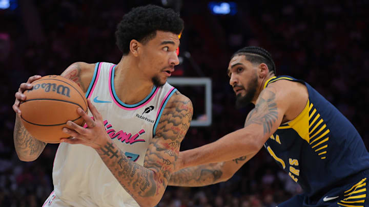 Feb 28, 2025; Miami, Florida, USA; Miami Heat center Kel'el Ware (7) protects the basketball from Indiana Pacers forward Obi Toppin (1) during the third quarter at Kaseya Center. Mandatory Credit: Sam Navarro-Imagn Images