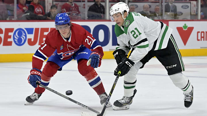 Feb 10, 2024; Montreal, Quebec, CAN; Montreal Canadiens defenseman Kaiden Guhle (21) and Dallas Stars forward Jason Robertson (21) battle for the puck during the third period at the Bell Centre. Mandatory Credit: Eric Bolte-Imagn Images