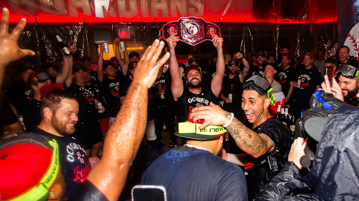 Sep 27, 2025: Cleveland Guardians catcher Austin Hedges, with belt, and shortstop Brayan Rocchio, right, along with the team and staff celebrate after the Guardians beat the Texas Rangers and clinched a playoff berth at Progressive Field. 