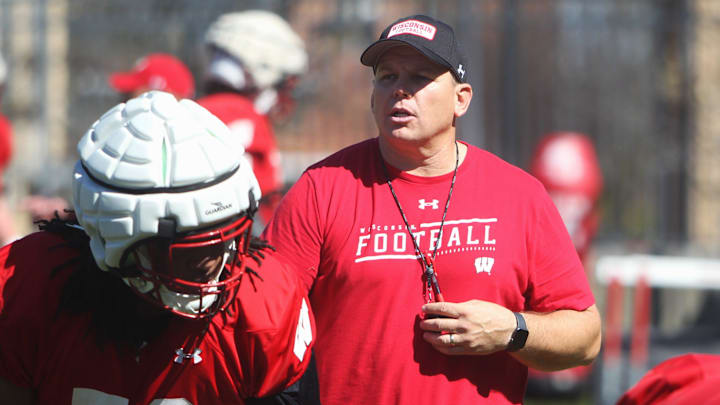 Wisconsin offensive line coach AJ Blazek works with Manny Mullens (58) during spring practice outside Camp Randall Stadium in Madison, Wisconsin on Saturday April 13, 2024
