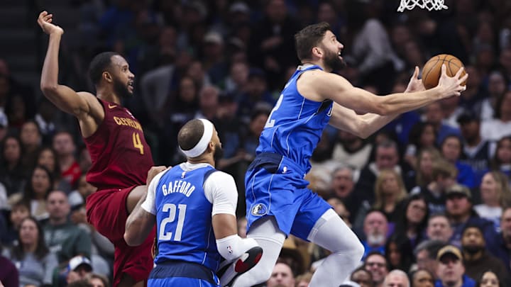 Jan 3, 2025; Dallas, Texas, USA; Dallas Mavericks forward Maxi Kleber (42) shoots past Cleveland Cavaliers forward Evan Mobley (4) during the first half at American Airlines Center. Mandatory Credit: Kevin Jairaj-Imagn Images