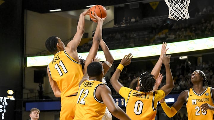 Mar 1, 2025; Nashville, Tennessee, USA;  Missouri Tigers guard Trent Pierce (11) blocks the shot of Vanderbilt Commodores forward Devin McGlockton (99) during the first half at Memorial Gymnasium. Mandatory Credit: Steve Roberts-Imagn Images