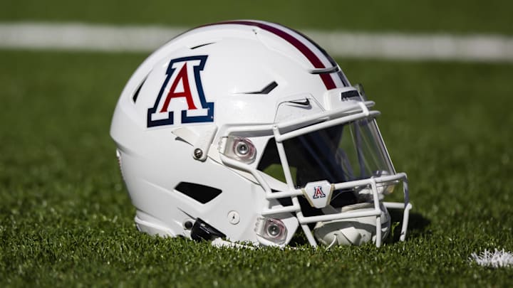 Nov 25, 2022; Tucson, Arizona, USA; Detailed view of an Arizona Wildcats helmet on the field during the Territorial Cup at Arizona Stadium. Mandatory Credit: Mark J. Rebilas-Imagn Images Nov 25, 2022; Tucson, Arizona, USA; Detailed view of an Arizona Wildcats helmet on the field during the Territorial Cup at Arizona Stadium. Mandatory Credit: Mark J. Rebilas-Imagn Images