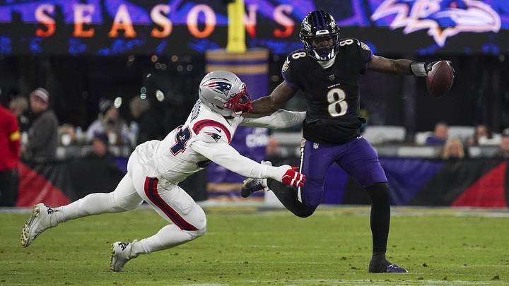 Dec 21, 2025; Baltimore, Maryland, USA; Baltimore Ravens quarterback Lamar Jackson (8) stiff arms New England Patriots linebacker K'Lavon Chaisson (44) during the first half of the game at M&T Bank Stadium. Mandatory Credit: James Lang-Imagn Images Dec 21, 2025; Baltimore, Maryland, USA; Baltimore Ravens quarterback Lamar Jackson (8) stiff arms New England Patriots linebacker K'Lavon Chaisson (44) during the first half of the game at M&T Bank Stadium. Mandatory Credit: James Lang-Imagn Images