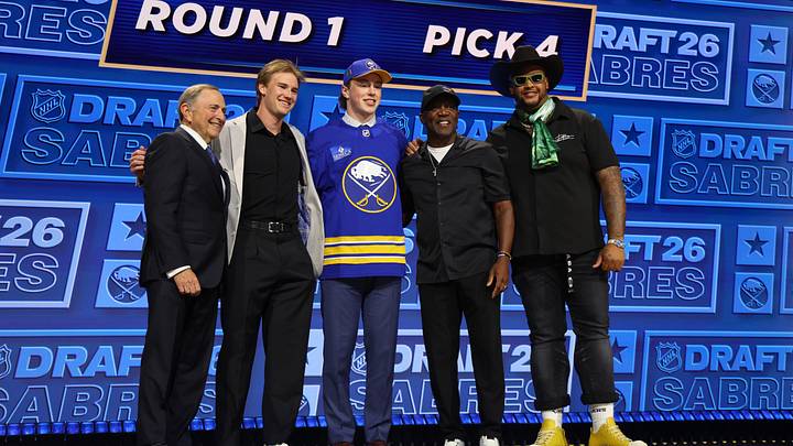 Jun 26, 2026; Buffalo, New York, USA; Daxon Rudolph poses with (from left) NHL commissioner Gary Bettman, Buffalo Sabres player Josh Doan, Buffalo Bills former player Thurman Thomas and Bills player Dion Dawkins as  after being selected with the fourth pick in the first round of the 2026 NHL Draft by the Sabres at KeyBank Center. Mandatory Credit: Timothy T. Ludwig-Imagn Images