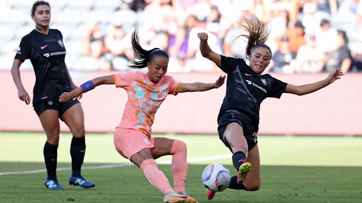Jun 30, 2024; Los Angeles, California, USA; Orlando Pride forward Adriana Leal da Silva (9) kicks the ball against Angel City FC defender Madison Curry (27) during the second half at BMO Stadium. Mandatory Credit: Kiyoshi Mio-USA TODAY Sports