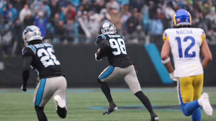 Nov 30, 2025; Charlotte, North Carolina, USA; Carolina Panthers linebacker D.J. Wonnum (98) returns a recovered fumble during the fourth quarter against the Los Angeles Rams at Bank of America Stadium. Mandatory Credit: Scott Kinser-Imagn Images Nov 30, 2025; Charlotte, North Carolina, USA; Carolina Panthers linebacker D.J. Wonnum (98) returns a recovered fumble during the fourth quarter against the Los Angeles Rams at Bank of America Stadium. Mandatory Credit: Scott Kinser-Imagn Images