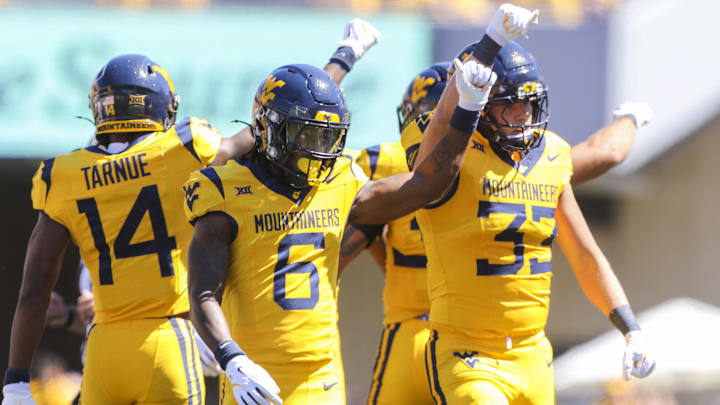 Aug 30, 2025; Morgantown, West Virginia, USA; West Virginia Mountaineers quarterback Max Brown (6) and others celebrate a defensive stop during the first quarter against the Robert Morris Colonials at Milan Puskar Stadium. Mandatory Credit: Ben Queen-Imagn Images Aug 30, 2025; Morgantown, West Virginia, USA; West Virginia Mountaineers quarterback Max Brown (6) and others celebrate a defensive stop during the first quarter against the Robert Morris Colonials at Milan Puskar Stadium. Mandatory Credit: Ben Queen-Imagn Images