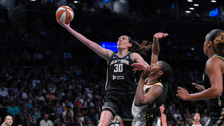 Jul 16, 2025; Brooklyn, New York, USA; New York Liberty forward Breanna Stewart (30) drives to the basket while defended by Indiana Fever forward Aliyah Boston (7) during the first half at Barclays Center. Mandatory Credit: John Jones-Imagn Images