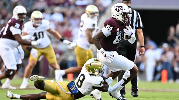 Aug 31, 2024; College Station, Texas, USA; Texas A&M Aggies tight end Tre Watson (84) runs the ball as Notre Dame Fighting Irish safety Adon Shuler (8) defends during the second quarter at Kyle Field. Mandatory Credit: Maria Lysaker-Imagn Images
