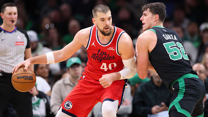 Nov 16, 2025; Boston, Massachusetts, USA; Boston Celtics forward Luka Garza (52) defends Los Angeles Clippers center Ivica Zubac (40) during the first half at TD Garden. Mandatory Credit: Paul Rutherford-Imagn Images