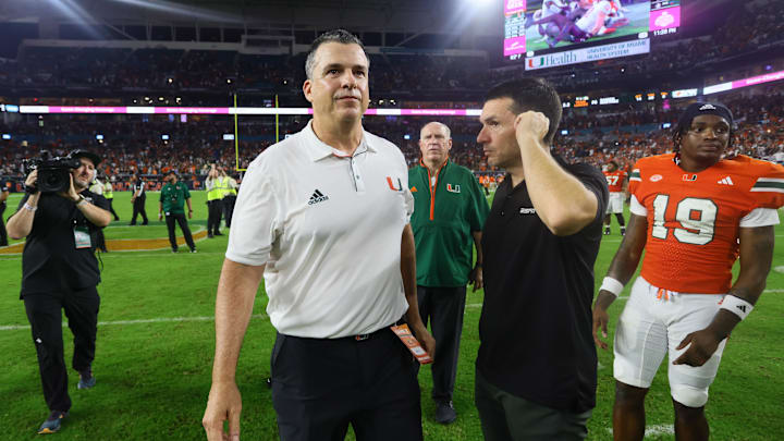 Sep 27, 2024; Miami Gardens, Florida, USA; Miami Hurricanes head coach Mario Cristobal walks on the field against the Virginia Tech Hokies as game officials review the last play of the game at Hard Rock Stadium. Mandatory Credit: Sam Navarro-Imagn Images