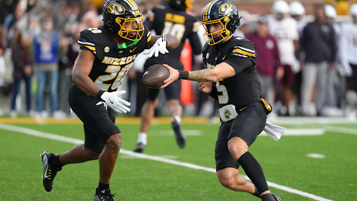 Missouri Tigers quarterback Matt Zollers (5) hands to running back Jamal Roberts (20) in a game versus the Texas A&M Aggies this season. Missouri Tigers quarterback Matt Zollers (5) hands to running back Jamal Roberts (20) in a game versus the Texas A&M Aggies this season.