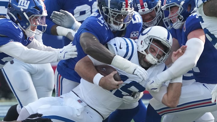 Dec 29, 2024; East Rutherford, New Jersey, USA; Indianapolis Colts quarterback Joe Flacco (15) is stopped by the Giants defense during the first quarter at MetLife Stadium. Mandatory Credit: Robert Deutsch-Imagn Images