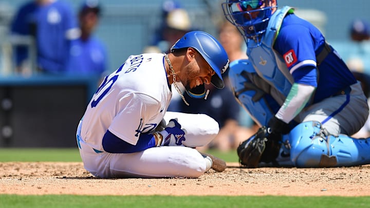 Jun 16, 2024; Los Angeles, California, USA; Los Angeles Dodgers shortstop Mookie Betts (50) reacts after being hit by pitch from Kansas City Royals pitcher Dan Altavilla (54) during the seventh inning at Dodger Stadium. Mandatory Credit: Gary A. Vasquez-USA TODAY Sports