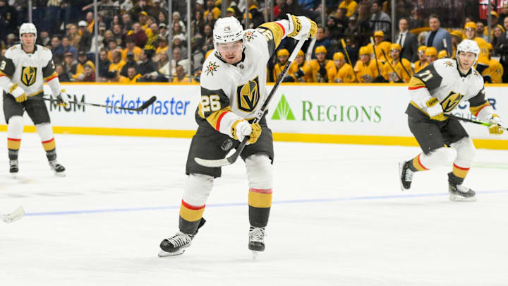 Jan 14, 2025; Nashville, Tennessee, USA;  Vegas Golden Knights right wing Alexander Holtz (26) skates with the puck against the Nashville Predators during the second period at Bridgestone Arena. Mandatory Credit: Steve Roberts-Imagn Images