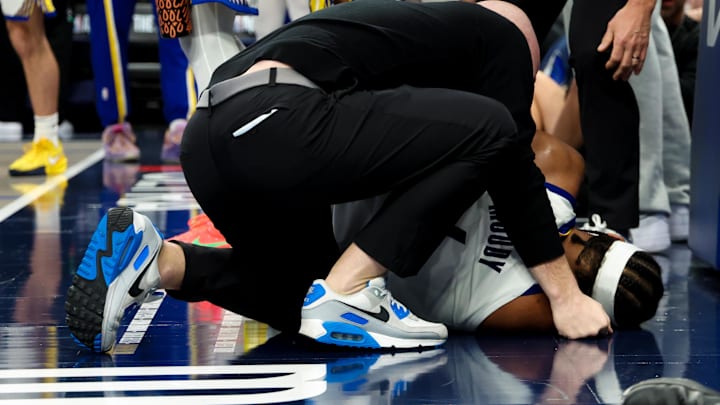 Mar 23, 2026; Dallas, Texas, USA;  Golden State Warriors guard Moses Moody (4) lays injured during overtime against the Dallas Mavericks at American Airlines Center. Mandatory Credit: Kevin Jairaj-Imagn Images
